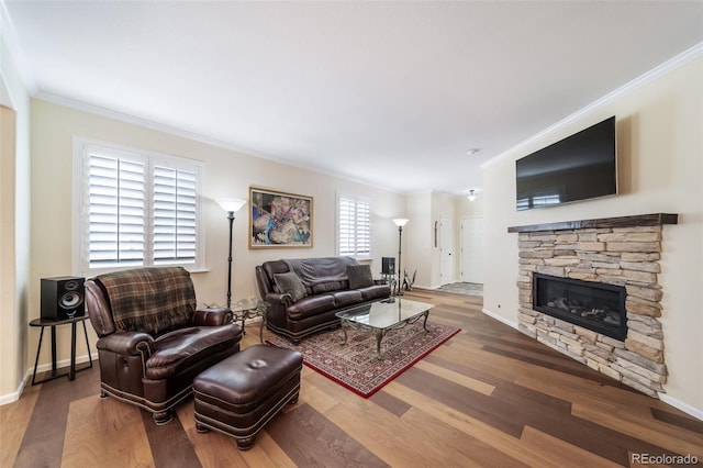 living room with a fireplace, ornamental molding, and hardwood / wood-style flooring