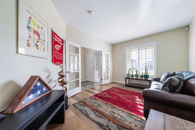 living room featuring french doors and hardwood / wood-style flooring