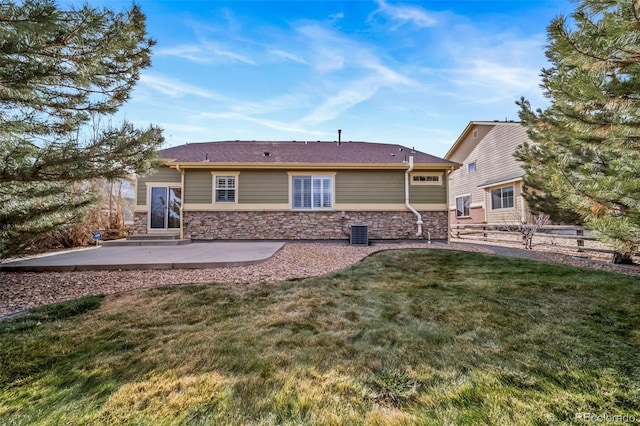 rear view of house featuring a lawn, a patio area, and cooling unit