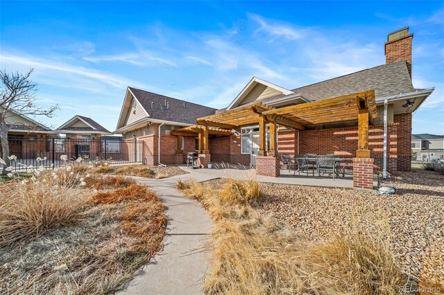 view of front of property featuring a pergola and a patio