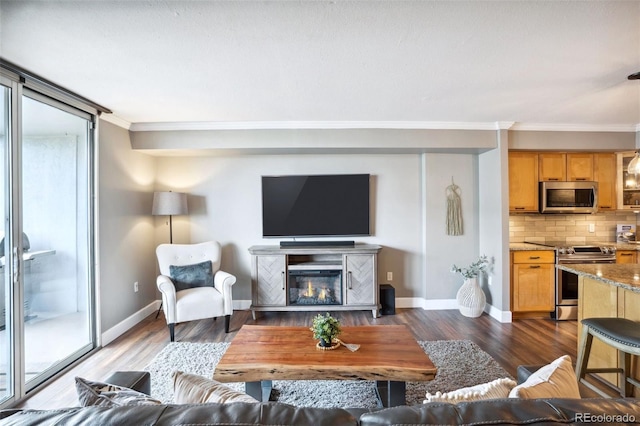 living room with dark hardwood / wood-style floors and crown molding