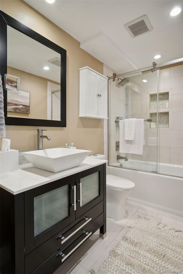 full bathroom with shower / bath combination with glass door, vanity, and toilet