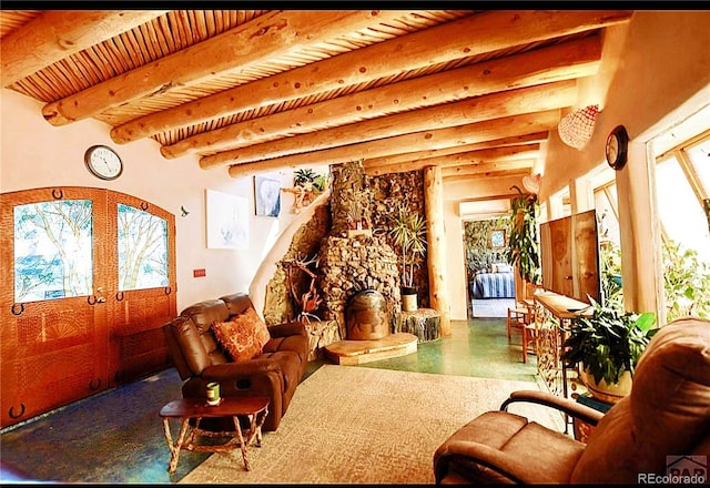 living room with wood ceiling, beam ceiling, a wall mounted AC, a fireplace, and french doors