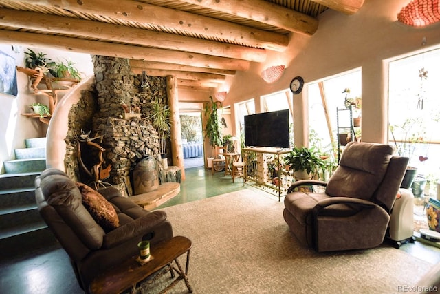 living room with wood ceiling, beam ceiling, and a fireplace