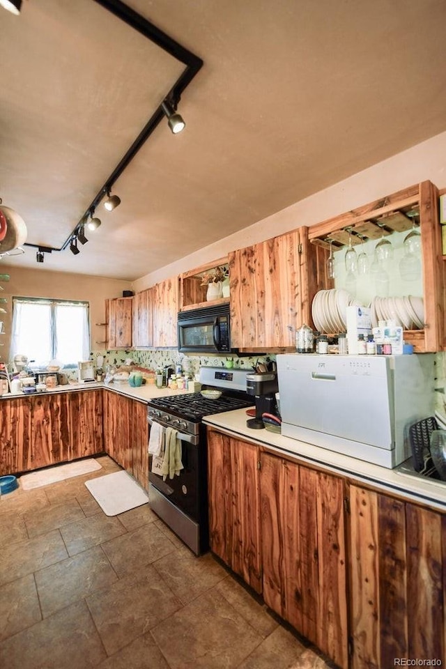 kitchen featuring tasteful backsplash and stainless steel range with gas stovetop