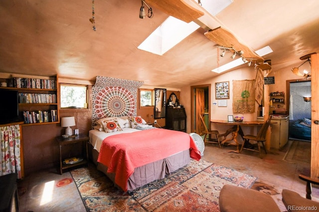 bedroom with lofted ceiling and multiple windows