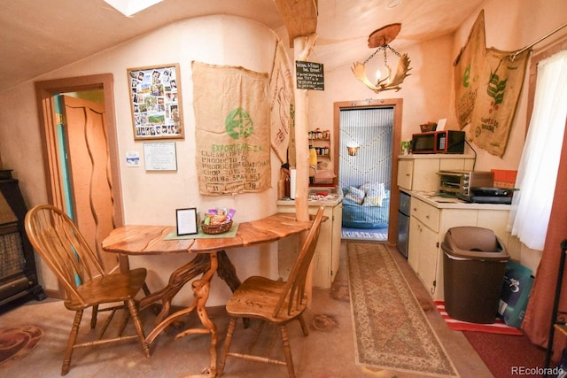 dining area with vaulted ceiling and a notable chandelier