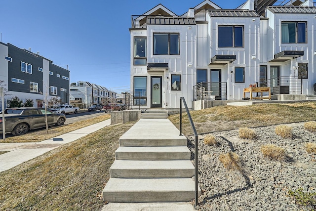 multi unit property featuring board and batten siding and a residential view