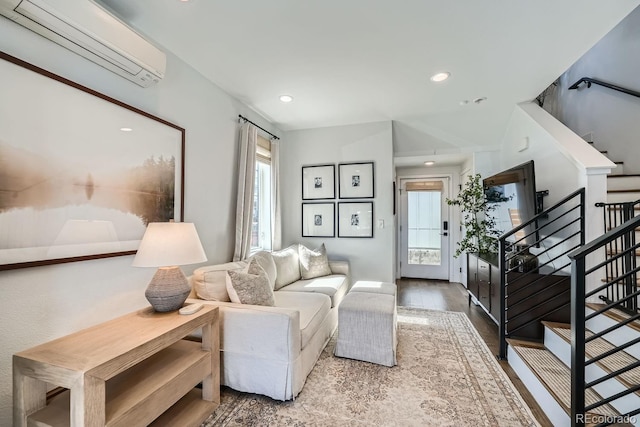 living area with recessed lighting, wood finished floors, stairway, and a wall mounted AC