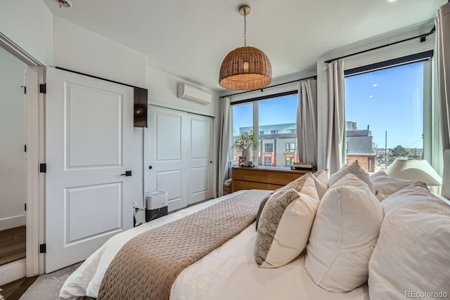 bedroom featuring a closet and a wall mounted AC