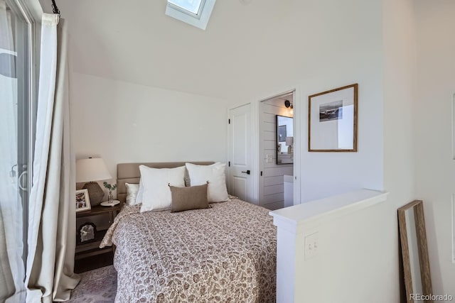 bedroom featuring vaulted ceiling with skylight