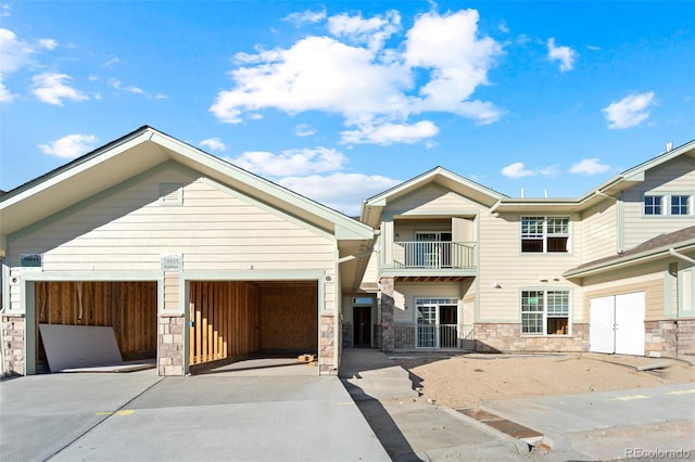 view of front of home featuring a garage and a balcony