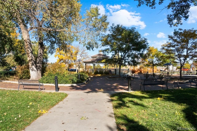 surrounding community with a gazebo and a yard