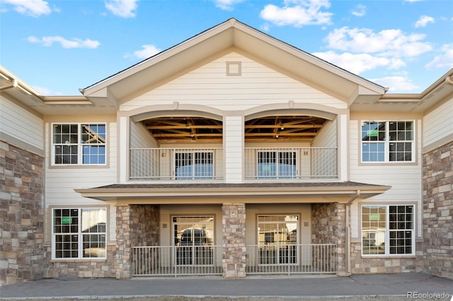 view of exterior entry featuring a balcony