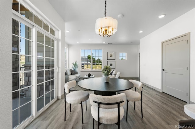 dining room featuring hardwood / wood-style flooring and a notable chandelier