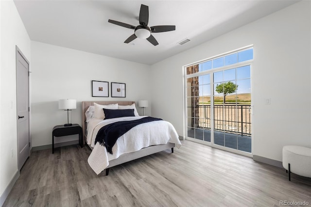 bedroom with wood-type flooring, access to exterior, and ceiling fan