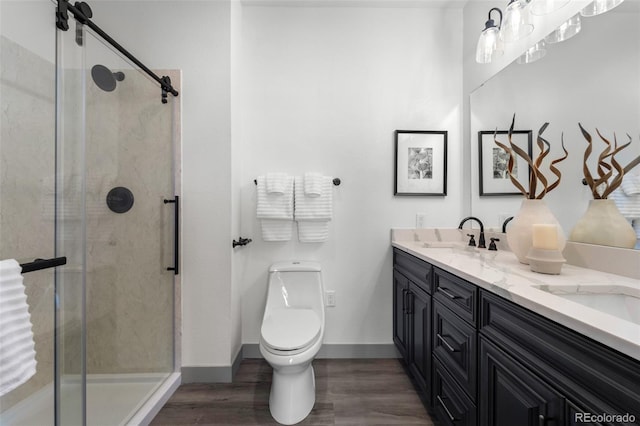 bathroom with vanity, an enclosed shower, hardwood / wood-style floors, and toilet