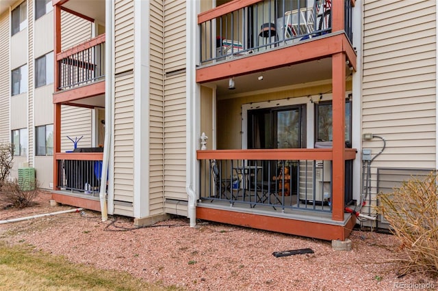 view of exterior entry featuring a balcony