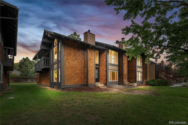 1347 S Crystal Way, Aurora, CO 80012 - back of house at dusk with a chimney and a yard