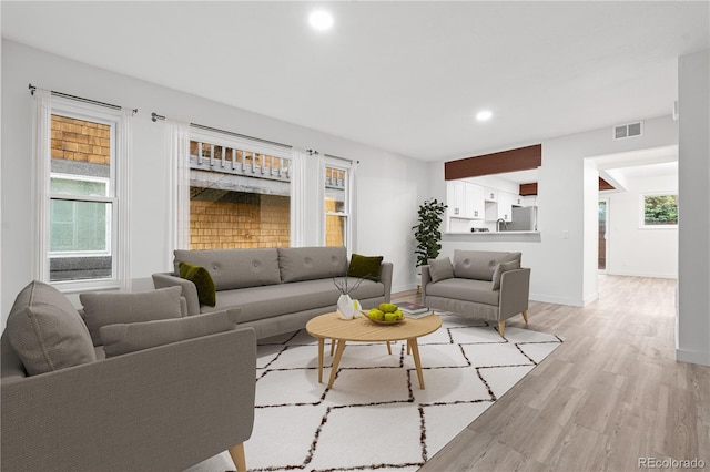 1347 S Crystal Way, Aurora, CO 80012 - living room featuring light wood-type flooring, recessed lighting, and baseboards