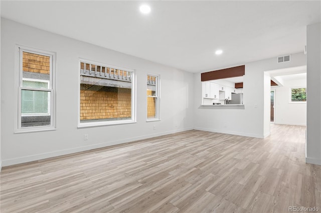 1347 S Crystal Way, Aurora, CO 80012 - unfurnished living room featuring light wood-style flooring, recessed lighting, and baseboards
