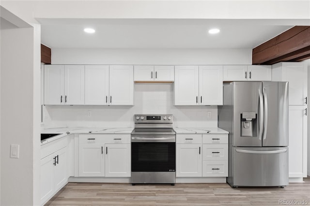 1347 S Crystal Way, Aurora, CO 80012 - kitchen featuring stainless steel appliances, white cabinetry, light stone countertops, light wood-style floors, and recessed lighting