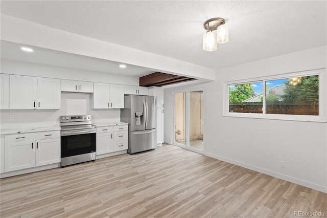 1347 S Crystal Way, Aurora, CO 80012 - kitchen featuring stainless steel appliances, light countertops, light wood-style floors, white cabinetry, and baseboards