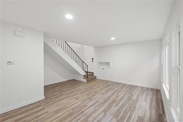 1347 S Crystal Way, Aurora, CO 80012 - unfurnished living room with light wood-style floors, stairs, recessed lighting, and baseboards