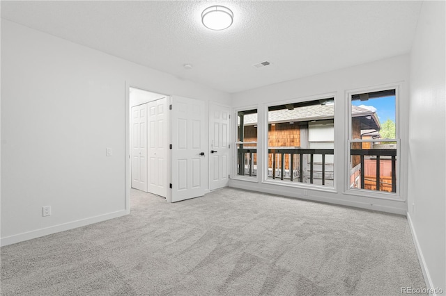 1347 S Crystal Way, Aurora, CO 80012 - carpeted empty room with baseboards and a textured ceiling