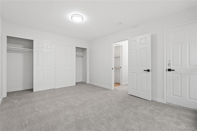 1347 S Crystal Way, Aurora, CO 80012 - unfurnished bedroom with carpet floors, a textured ceiling, a closet, and baseboards