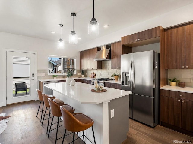 3640 Lipan St, Denver, CO 80211 - kitchen with appliances with stainless steel finishes, wall chimney exhaust hood, a kitchen bar, backsplash, and a sink