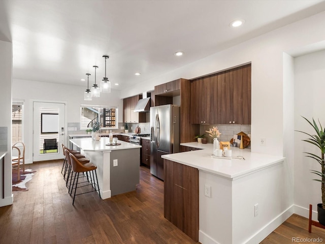 3640 Lipan St, Denver, CO 80211 - kitchen featuring stainless steel appliances, modern cabinets, a breakfast bar, light countertops, and backsplash