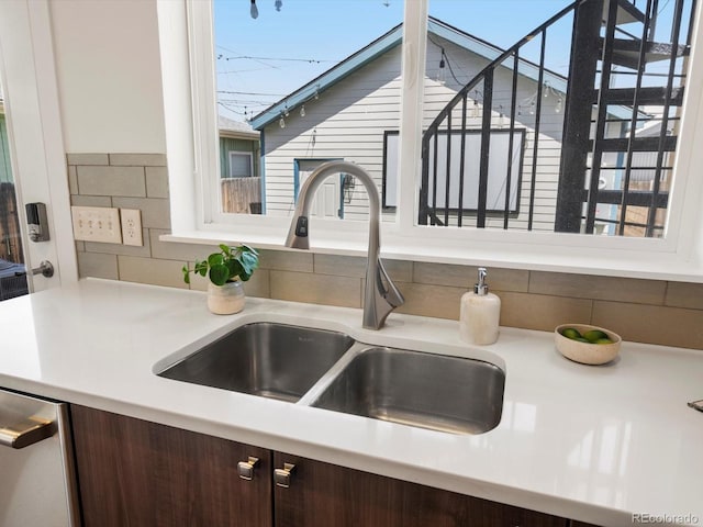 3640 Lipan St, Denver, CO 80211 - kitchen view of a sink, dark brown cabinets, light countertops, dishwasher, and decorative backsplash