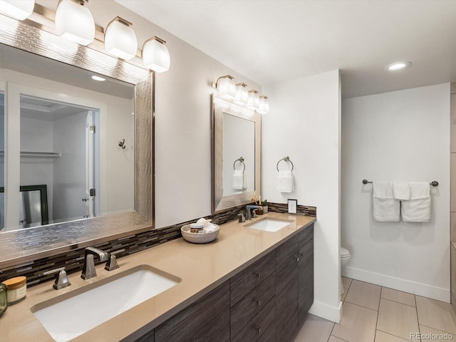 3640 Lipan St, Denver, CO 80211 - bathroom featuring double vanity, toilet, baseboards, tile patterned floors, and recessed lighting