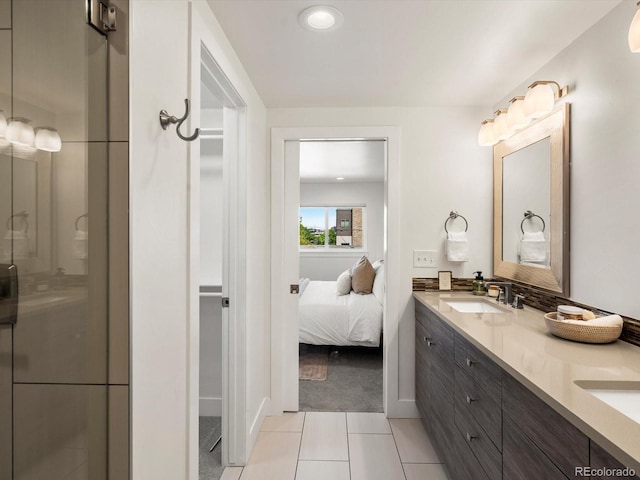 3640 Lipan St, Denver, CO 80211 - bathroom with double vanity, tile patterned flooring, a stall shower, connected bathroom, and baseboards