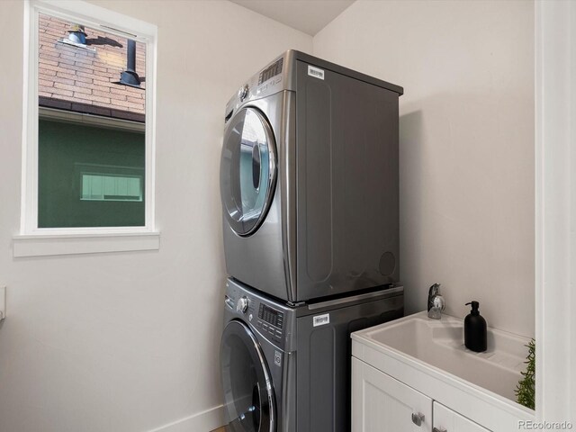 3640 Lipan St, Denver, CO 80211 - laundry room featuring stacked washer / dryer and cabinet space