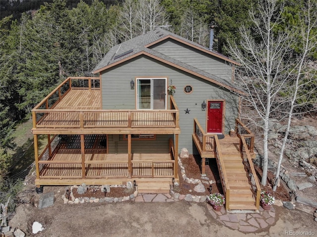 234 Bailey Dr, Bailey, CO 80421 - view of front of house with a deck, roof with shingles, and stairway