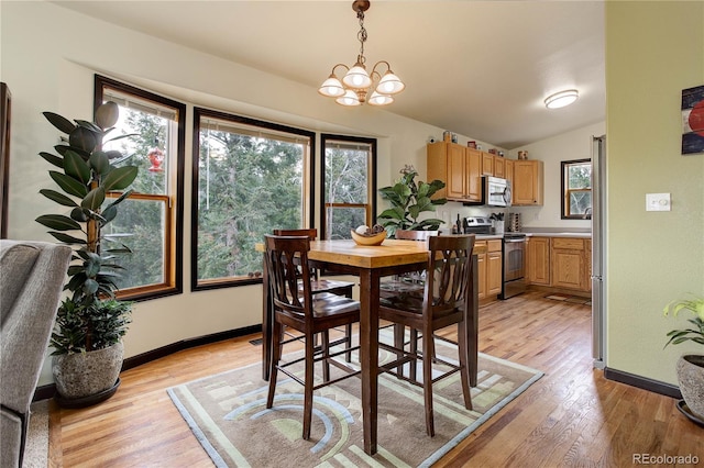 234 Bailey Dr, Bailey, CO 80421 - dining space featuring light wood-type flooring, baseboards, a chandelier, and vaulted ceiling