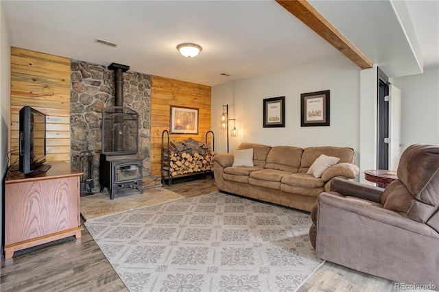 234 Bailey Dr, Bailey, CO 80421 - living room featuring wooden walls, wood finished floors, and a wood stove