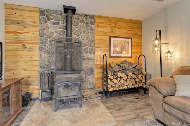 234 Bailey Dr, Bailey, CO 80421 - living area with a wood stove, wood finished floors, and wood walls
