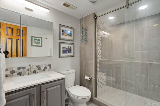 234 Bailey Dr, Bailey, CO 80421 - bathroom with toilet, vanity, a tile shower, and tasteful backsplash