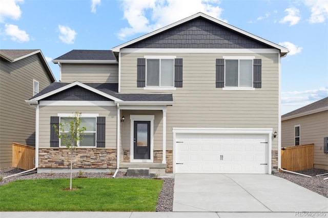 craftsman-style home featuring a garage and a front lawn