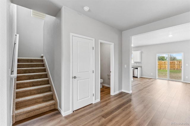 staircase with hardwood / wood-style floors