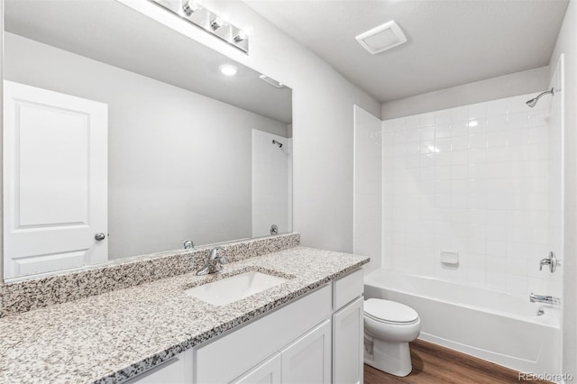 full bathroom with hardwood / wood-style flooring, shower / bathing tub combination, vanity, and toilet