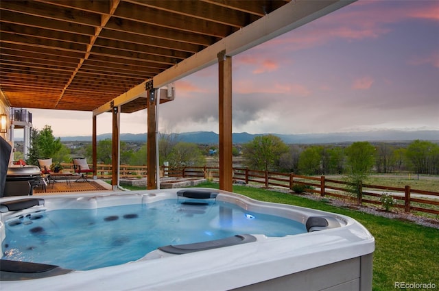 1601 Mariah Ln, Erie, CO 80516 - view of pool with a hot tub, a mountain view, and a grill