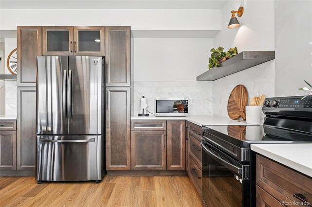 1601 Mariah Ln, Erie, CO 80516 - kitchen with stainless steel appliances, decorative backsplash, light wood-type flooring, and light countertops