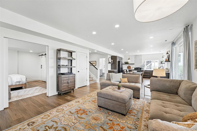 1601 Mariah Ln, Erie, CO 80516 - living area featuring stairway, wood finished floors, recessed lighting, and baseboards