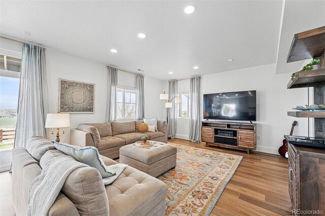 1601 Mariah Ln, Erie, CO 80516 - living room with recessed lighting, wood finished floors, and baseboards