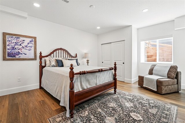 1601 Mariah Ln, Erie, CO 80516 - bedroom with wood finished floors, baseboards, a closet, and recessed lighting