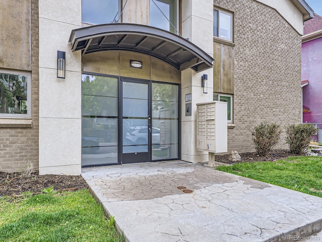 2460 W Caithness Pl Unit 105, Denver, CO 80211 - doorway to property with brick siding
